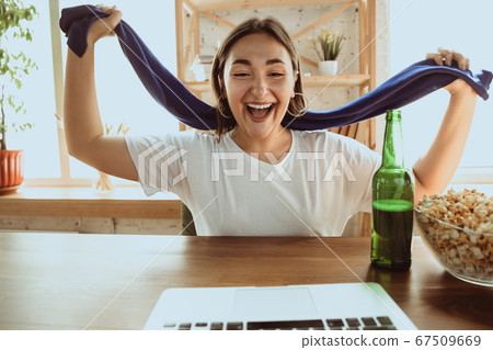 Excited football fan watching sport match at home, remote support of favourite team during coronavirus pandemic outbreak Excited football fan watching sport match at home, remote support of favourite team during coronavirus pandemic outbreak 67509669