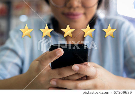 Woman using cell phone with 5 gold star customer satisfaction graphic Woman using cell phone with 5 gold star customer satisfaction graphic 67509689