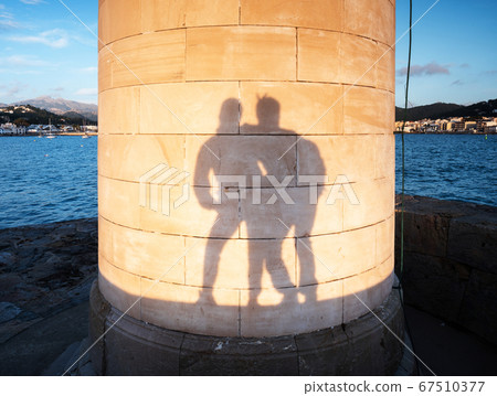 Lovers play with their shadows on Lighthouse Lovers play with their shadows on Lighthouse 67510377