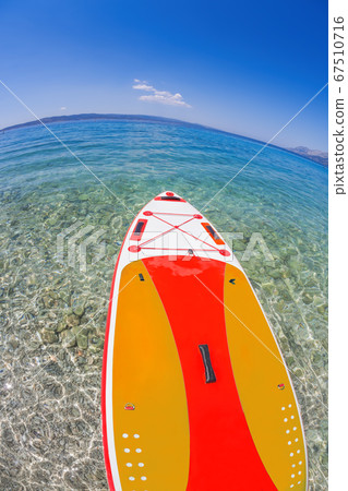 Colorful paddle board against azure sea in Brela, Croatia 67510716
