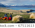 Two people laying and looking at Lake tekapo from Mount John observatory, South Island, New Zealand 67511613