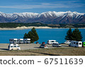 Freedom camp with campervans with blue Lake Pukaki and snow covered mountains in the background, South Island, New Zealand 67511639