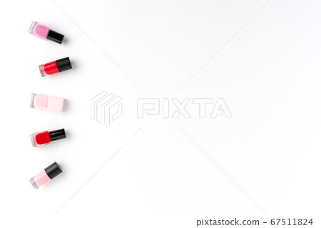 Red and pink nail polishes on white background with copyspace. Top view Red and pink nail polishes on white background with copyspace. Top view 67511824
