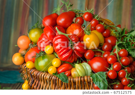 Tomatoes in wicker basket in the kitchen Tomatoes in wicker basket in the kitchen 67512575