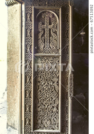 Wood cross on the front door of the Church of St. Hripsime in Echmiadzin 67513892
