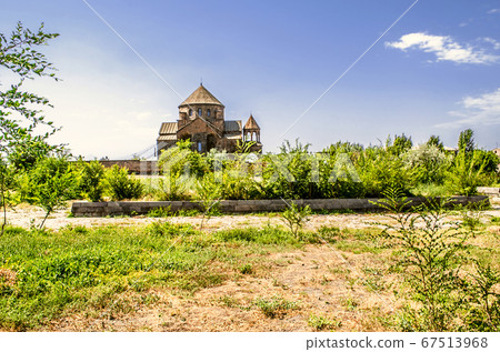 View of the path to the Church of the Holy great Martyr Hripsime surrounded by an orchard 67513968
