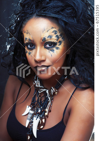 beauty afro girl with cat make up, creative leopard print on face closeup halloween woman beauty afro girl with cat make up, creative leopard print on face closeup halloween woman 67515395