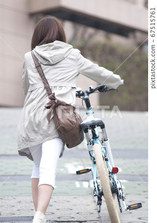 A woman riding a bicycle 67515761