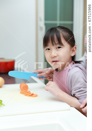 Girl helping mom cook Girl helping mom cook 67515966