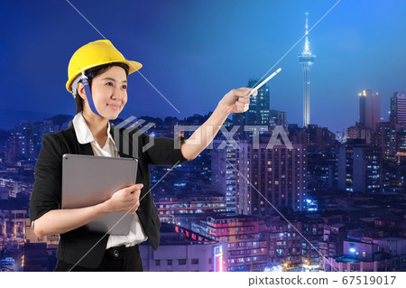 Young woman engineer holding digital tablet wtih 67519017