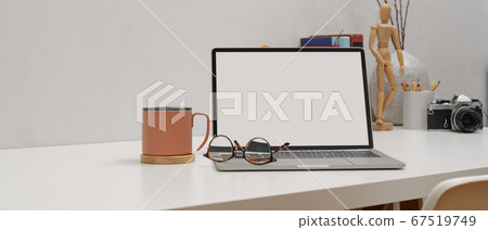 Simple worktable with mock up laptop, glasses, mug 67519749