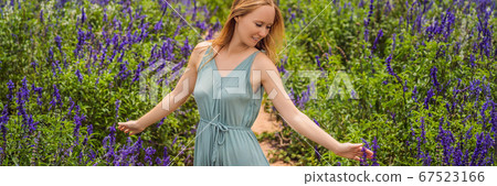 Beautiful woman relaxing in lavender field watching on sunset BANNER, LONG FORMAT Beautiful woman relaxing in lavender field watching on sunset BANNER, LONG FORMAT 67523166