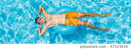 Young man swims in the pool, summer vacation concept BANNER, LONG FORMAT 67523616