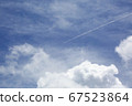 Contrails remaining between the blue sky and clouds 67523864
