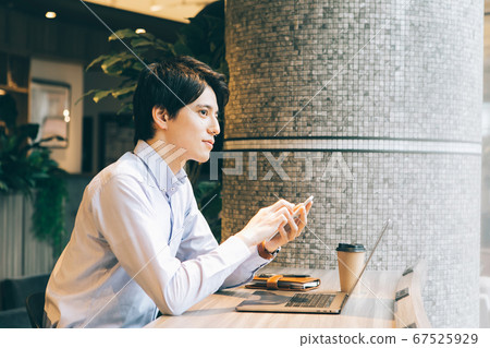 Businessman doing remote work in a shared office Businessman doing remote work in a shared office 67525929