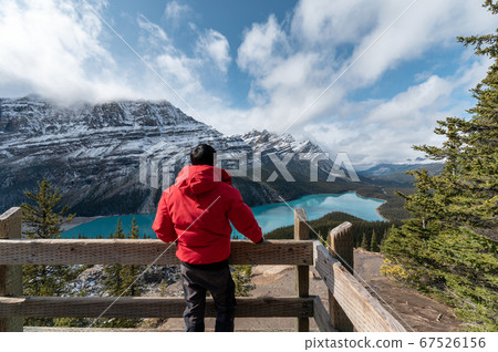 Man standing and looking the view of Peyto lake at Man standing and looking the view of Peyto lake at 67526156