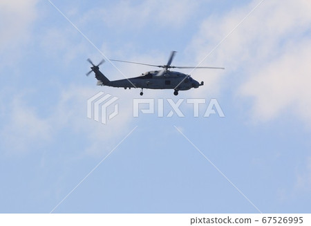 US Navy-based MH-60R Seahawk patrol helicopter that is also active in rescue operations while flying in the blue sky US Navy-based MH-60R Seahawk patrol helicopter that is also active in rescue operations while flying in the blue sky 67526995