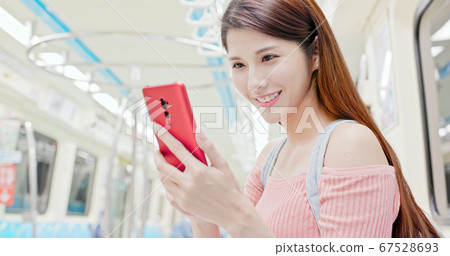 Girl use smartphone in metro Girl use smartphone in metro 67528693