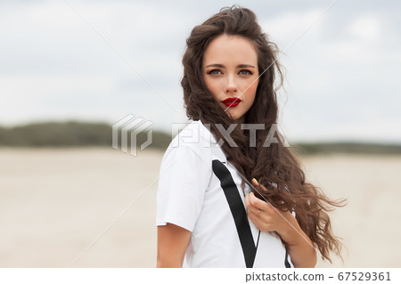 Charming woman on sandy beach Charming woman on sandy beach 67529361