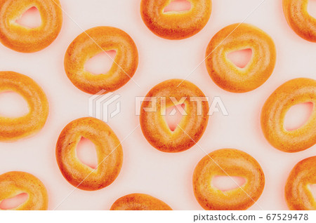 Small bagels on a pink background.Drying for Small bagels on a pink background.Drying for 67529478