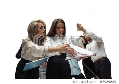 Nervous tensioned investors analyzing crisis stock market with charts on screen of their gadgets 67529689