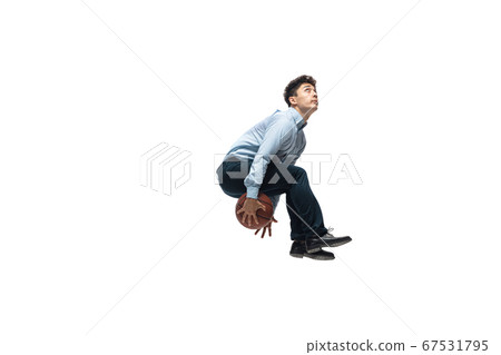 Man in office clothes playing basketball on white background. Unusual look for businessman in motion, action. Sport, healthy lifestyle. 67531795