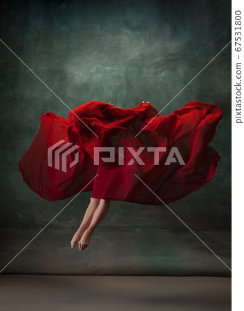 Young graceful tender ballerina on dark green studio background 67531800