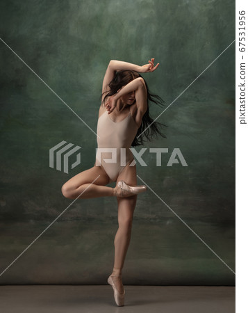 Young graceful tender ballerina on dark green studio background Young graceful tender ballerina on dark green studio background 67531956
