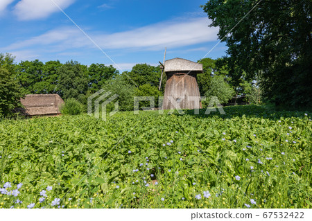 Wooden mill in the countryside. Wooden mill in the countryside. 67532422