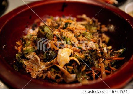 In a wooden bowl, put radish, fern, carrot, bean sprouts, egg, and red pepper paste, 67535243