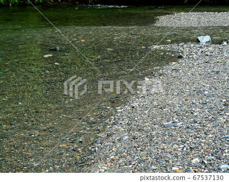 Clear water flowing through the mountains 67537130