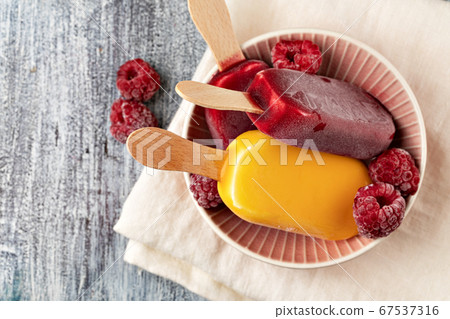 Fruit popsicles ice cream on a plate. 67537316