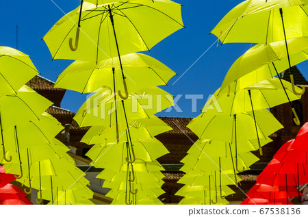 Colourful umbrellas urban street decoration. 67538136