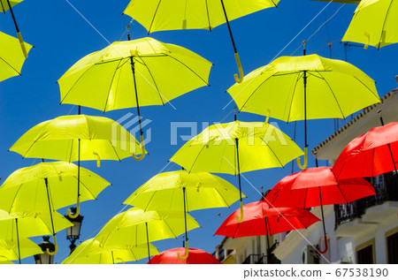 Colourful umbrellas urban street decoration. 67538190