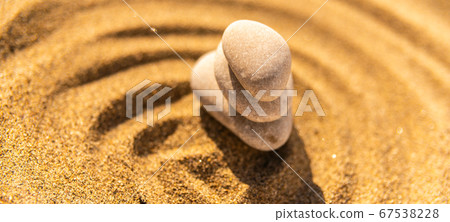 zen meditation stone in sand, concept for purity 67538228