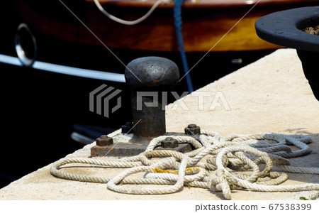 mooring post on the waterfront in a small marina, 67538399