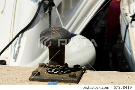 mooring post on the waterfront in a small marina, 67538419
