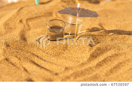 colorful shots drinks on a sandy beach with 67538597