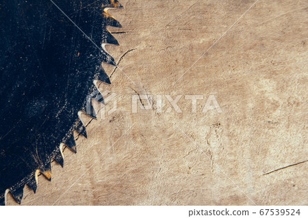Close-up blade circular saw on the background of the wooden table. Workshop for the production of wooden products. Joiner's cutting tool. Backdrop with free copy space. Top view Close-up blade circular saw on the background of the wooden table. Workshop for the production of wooden products. Joiner's cutting tool. Backdrop with free copy space. Top view 67539524