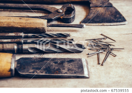 Old construction tools on a wooden workbench flat lay background. Carpenter table. Woodwork Old construction tools on a wooden workbench flat lay background. Carpenter table. Woodwork 67539555