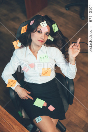 Overworking or Tired businesswoman with pasted note stickies sitting in office armchair looking up. High angle view. Multitasking concept. Tinted image Overworking or Tired businesswoman with pasted note stickies sitting in office armchair looking up. High angle view. Multitasking concept. Tinted image 67540104