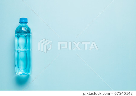 Drinking water bottle on blue background Drinking water bottle on blue background 67540142