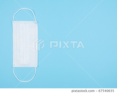 Medical mask against a blue background. Medical mask against a blue background. 67540635
