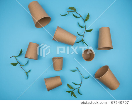 Paper cups on a blue background. 67540707