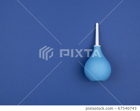 Enema bag on blue background. Enema bag on blue background. 67540743