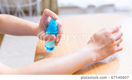 Female hands using insect repellent 16:9 67540807