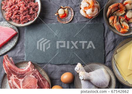 Animal protein sources background with copy space. Carnivore diet concept. Meat, cheese, fish, eggs and seafood Animal protein sources background with copy space. Carnivore diet concept. Meat, cheese, fish, eggs and seafood 67542662