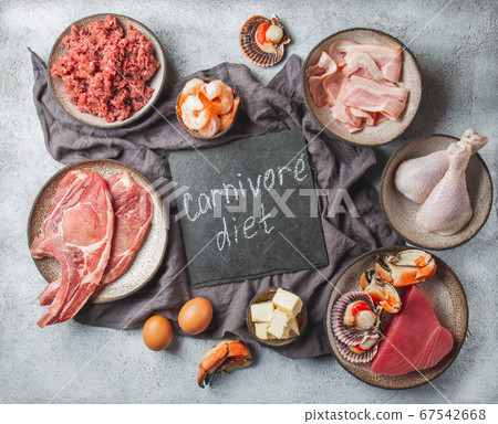 Carnivore diet concept. Raw ingredients for zero carb diet - fish, seafood, eggs, meat and animal fats. Top view or flat lay. Carnivore diet concept. Raw ingredients for zero carb diet - fish, seafood, eggs, meat and animal fats. Top view or flat lay. 67542668