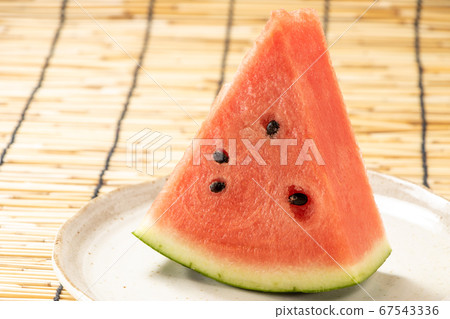 Watermelon (cut). Summer image in the background blinds. 67543336