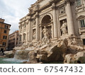 Trevi Fountain where light shines through the gaps in the clouds 67547432